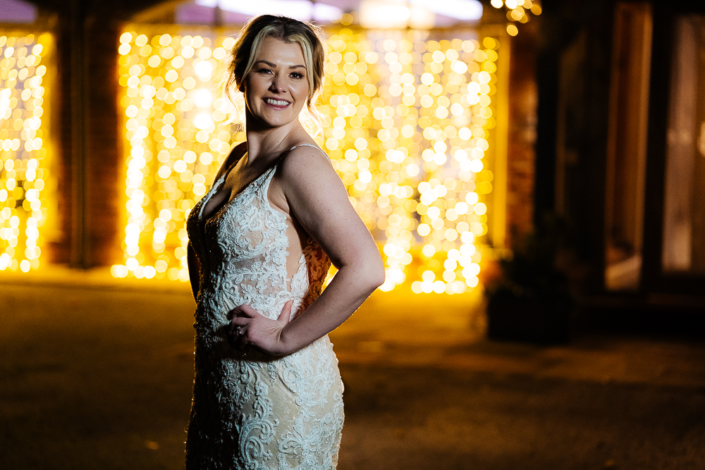 bride in front of fairy lights