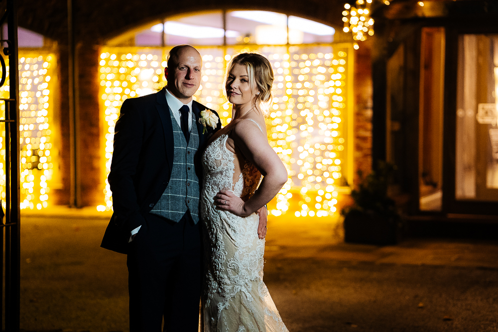 bride and groom with fairy lights