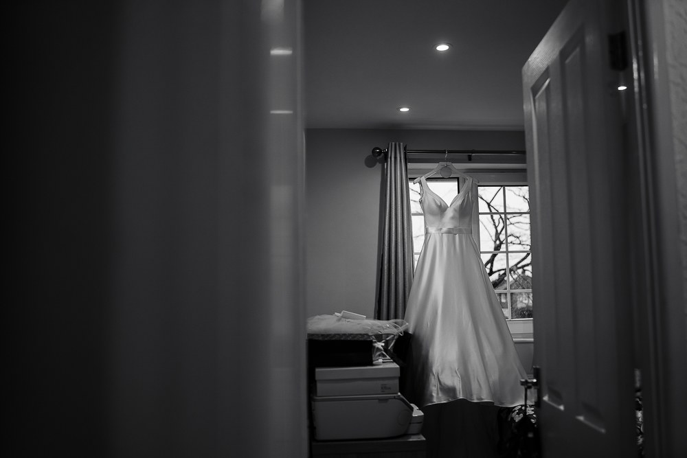 wedding dress hanging in bedroom window
